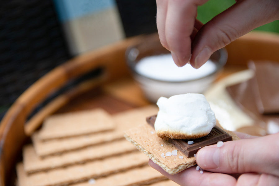 Person Sprinkling Salt On Top Of Smore