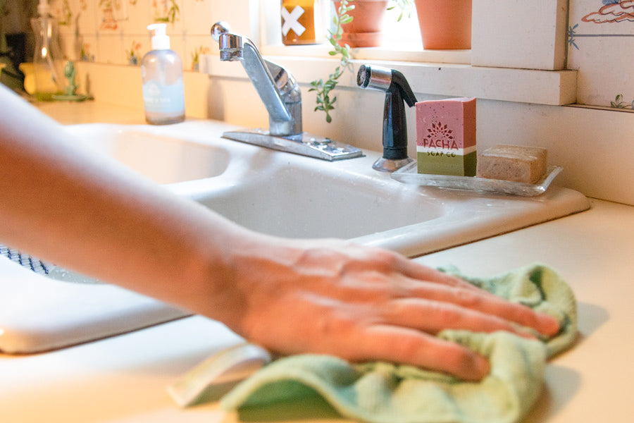 Person Cleaning Kitchen Counter with Watermelon Bar Soap Sitting by the Sink